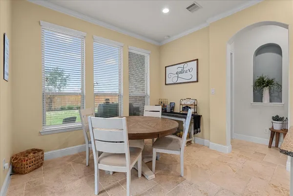 a large kitchen with cabinets table and chairs
