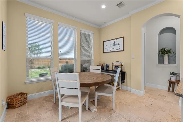 a large kitchen with cabinets table and chairs