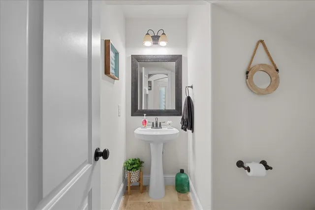 a room with pool table and windows