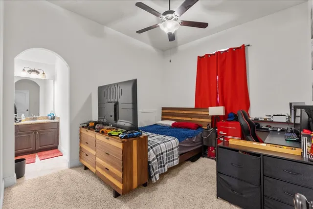 a bathroom with a granite countertop sink a toilet and a mirror