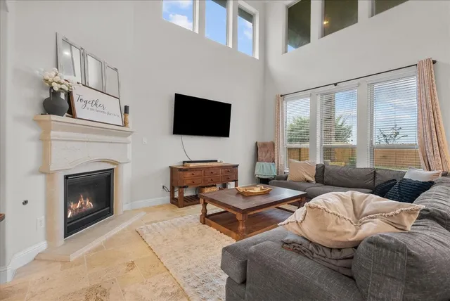 a living room with a couch a flat screen tv and a fireplace