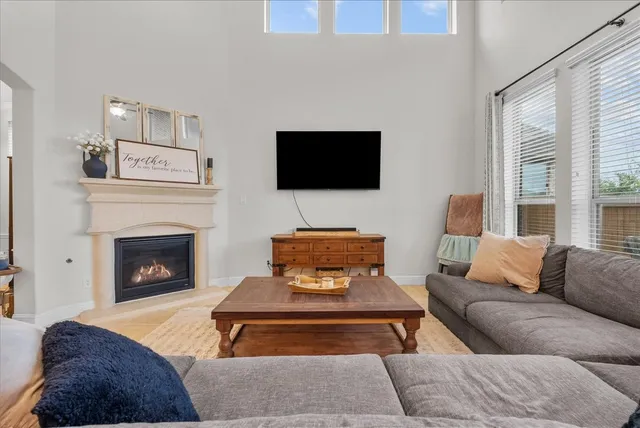 a living room with furniture kitchen view and a fireplace