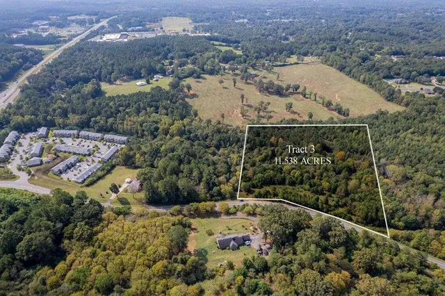 an aerial view of a house with a yard and lake view