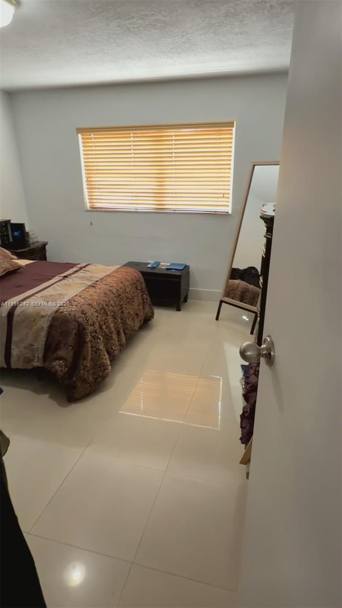 1225 West 35th Street, Unit 2A Hialeah, FL 33012 - Photo 1 of 3 a bedroom with a bed and a window