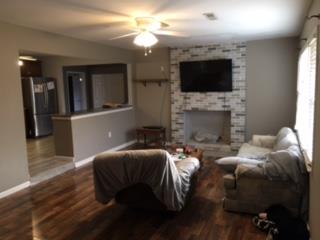 7156 Bahne Road Fairview, TN 37062 - Photo 2 of 5 a living room with furniture a flat screen tv and a fireplace