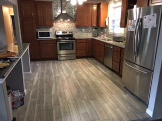 7156 Bahne Road Fairview, TN 37062 - Photo 3 of 5 a kitchen with granite countertop a refrigerator stove and sink