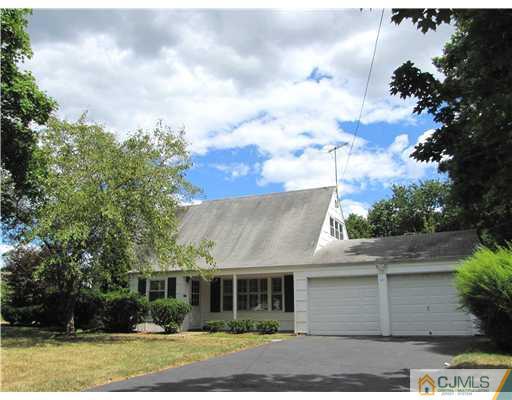 11 Hughes Road Somerset, NJ 08873 - Photo 1 of 9 a front view of a house with a garden and trees