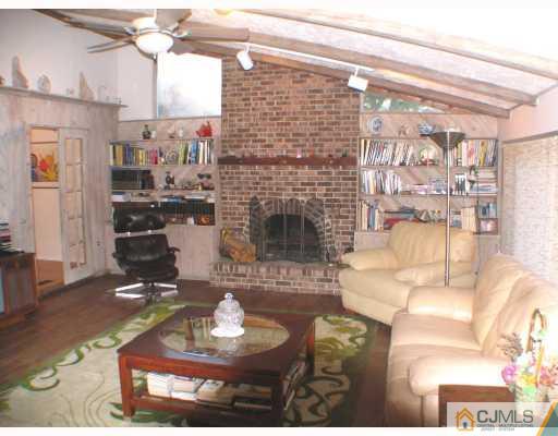 11 Hughes Road Somerset, NJ 08873 - Photo 4 of 9 a living room with furniture and a fireplace