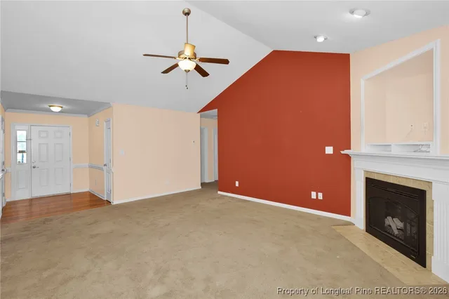 a view of a livingroom with a fireplace and fan