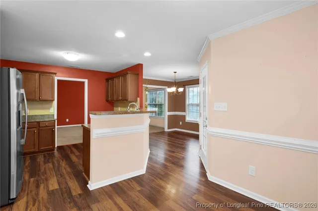 a kitchen with stainless steel appliances a refrigerator and a stove top oven
