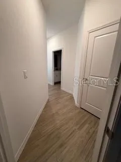 a view of a hallway and wooden floor