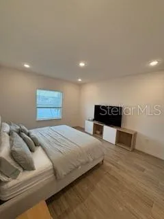 a bedroom with bed and a couch