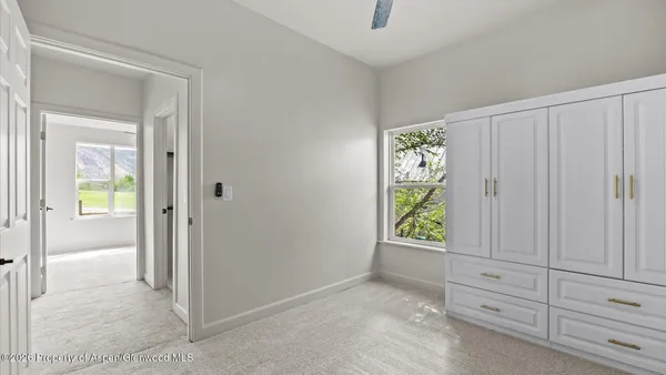a view of an entryway with wooden floor