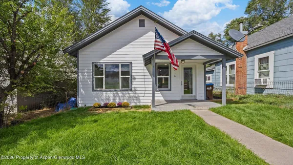 a front view of a house with a yard and porch