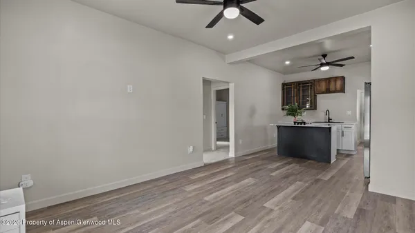 a view of a kitchen with a sink and a refrigerator
