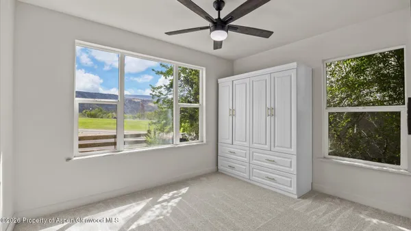 a view of room with window and ceiling fan