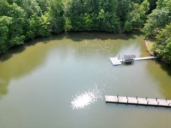 an aerial view of a house with a yard and lake view