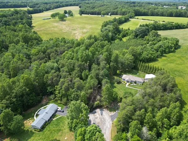 an aerial view of a house with a yard