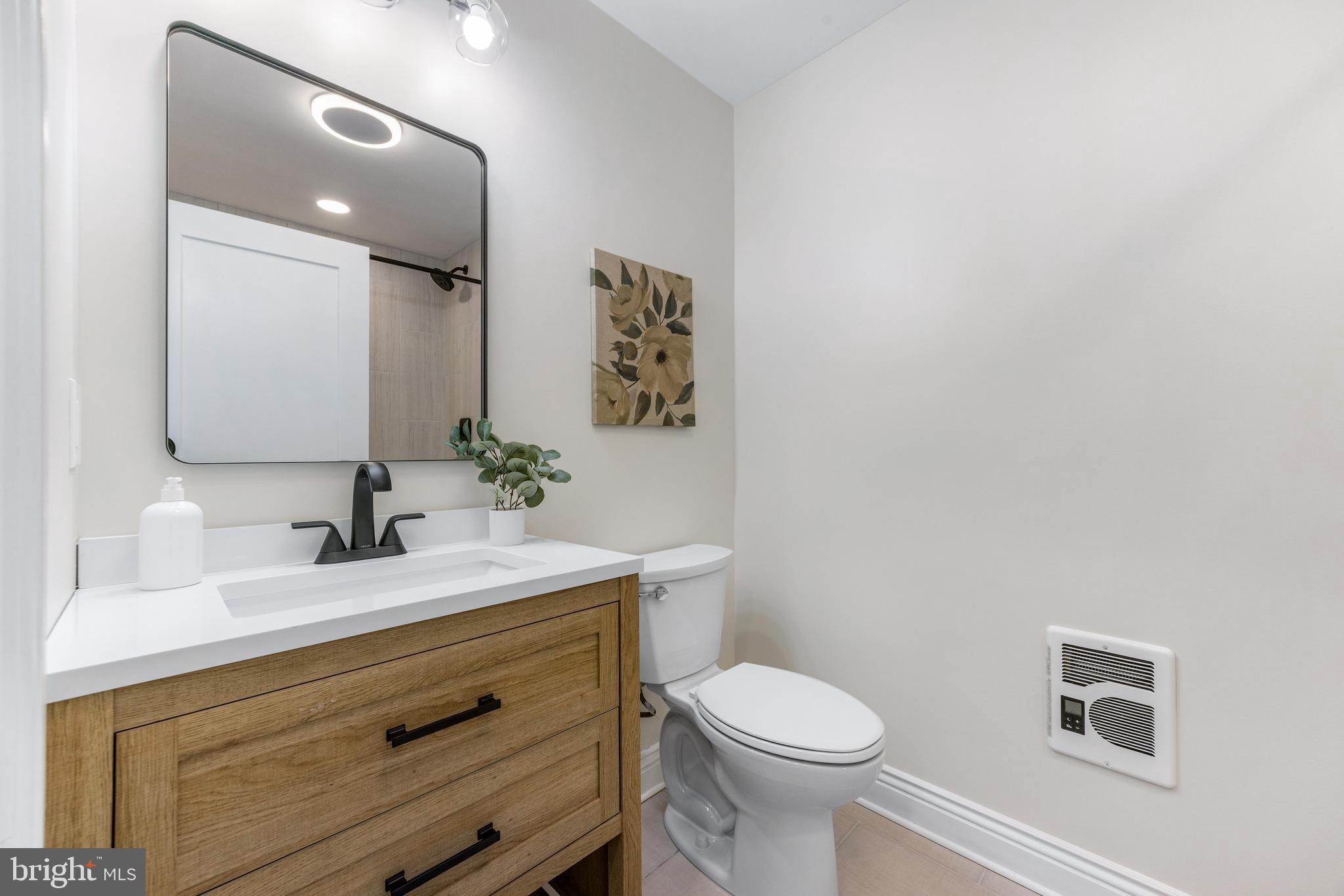 30 East Broadway, Unit AT 1 Bel Air, MD 21014 - Photo 29 of 34 a bathroom with a sink a toilet and mirror