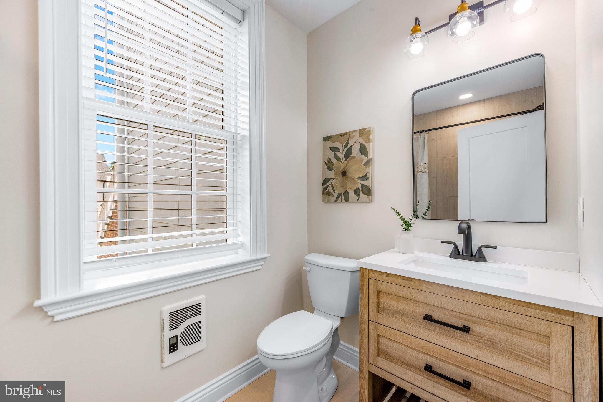 30 East Broadway, Unit AT 1 Bel Air, MD 21014 - Photo 31 of 34 a bathroom with a toilet sink and mirror
