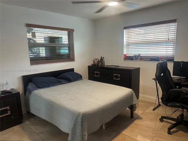 a bedroom with two beds and a window