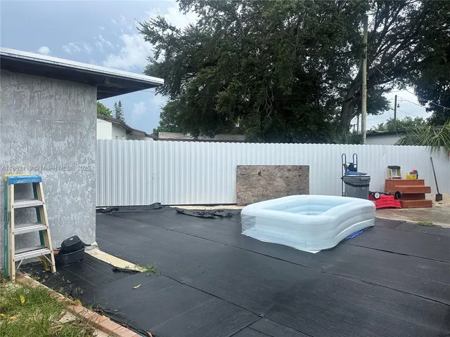 a view of a patio with table and chairs