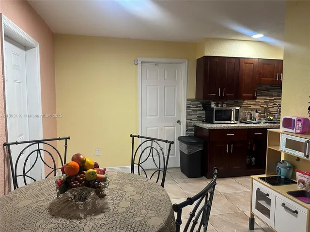 a kitchen with a table and chairs