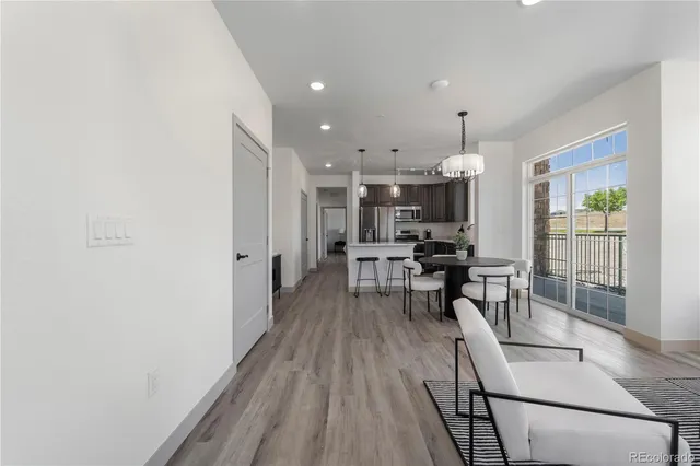 a view of a kitchen with dining room and wooden floor