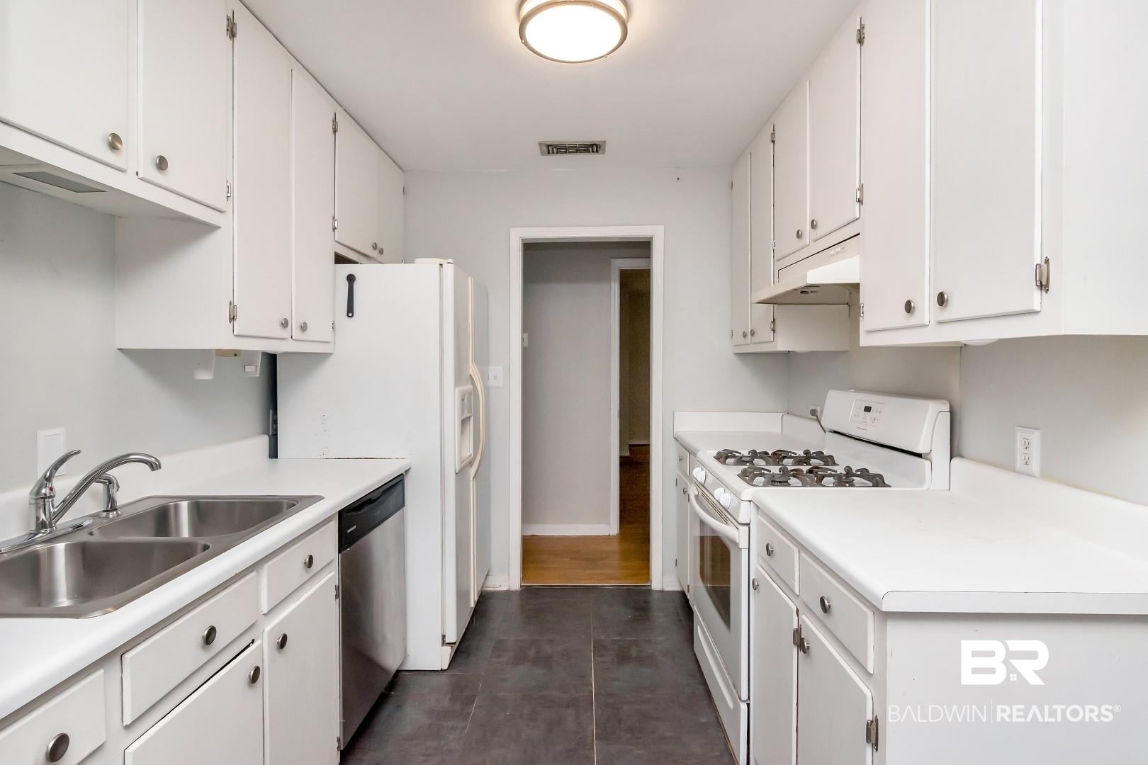 320 Vanderbilt Drive Mobile, AL 36608 - Photo 20 of 39 Kitchen featuring white range with gas stovetop, sink, and white cabinets