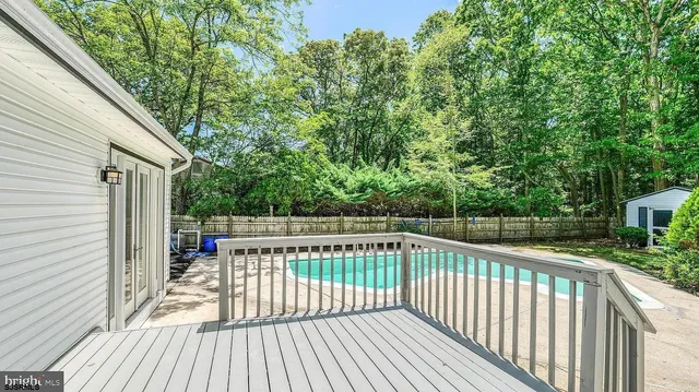 a view of a backyard with swimming pool