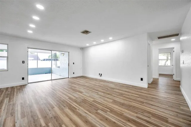 a room with kitchen island a wooden floor and a sink