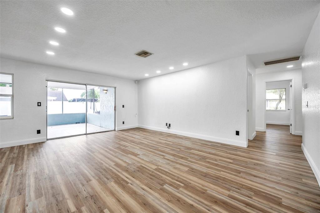 1520 Windmill Pointe Road Palm Harbor, FL 34685 - Photo 12 of 64 a view of empty room with wooden floor and fan