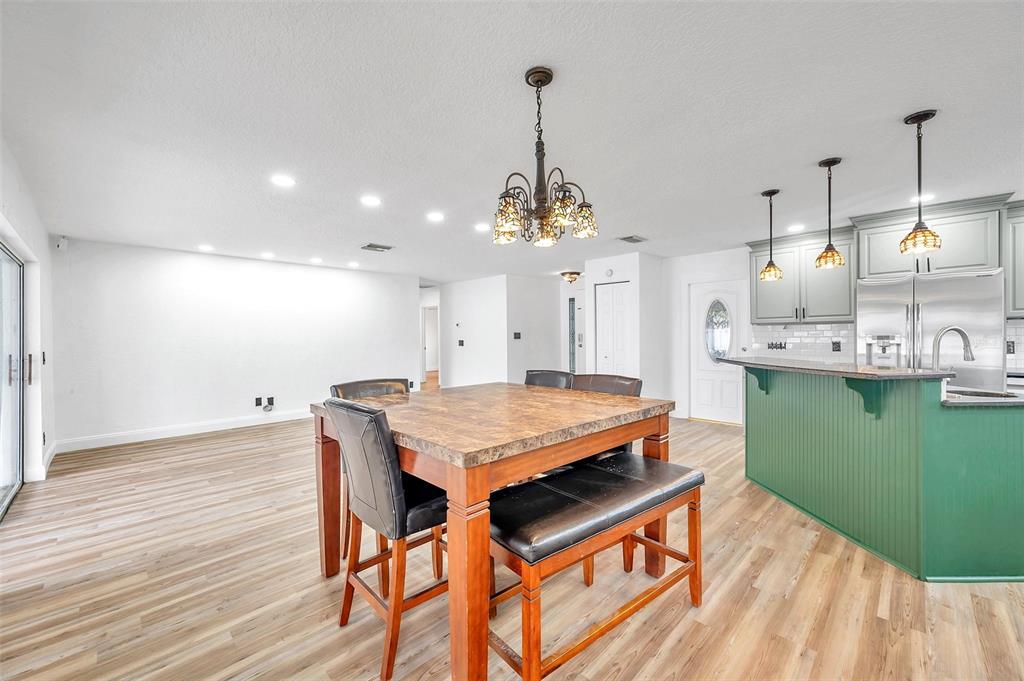1520 Windmill Pointe Road Palm Harbor, FL 34685 - Photo 15 of 64 a room with kitchen island a wooden floor and a sink