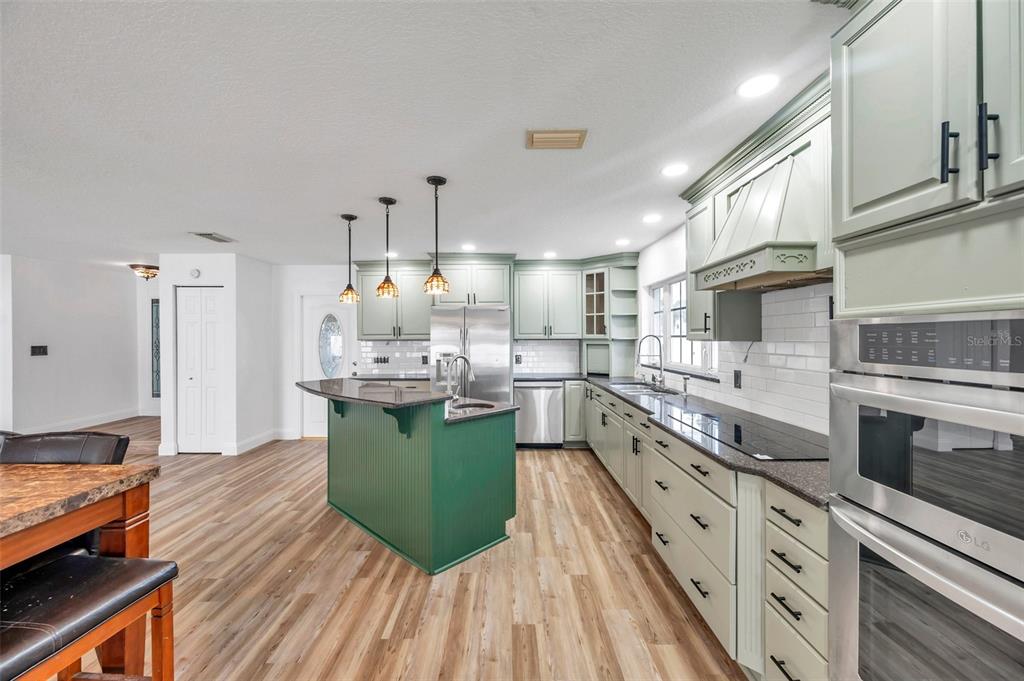 1520 Windmill Pointe Road Palm Harbor, FL 34685 - Photo 17 of 64 a kitchen with lots of counter top space and stainless steel appliances