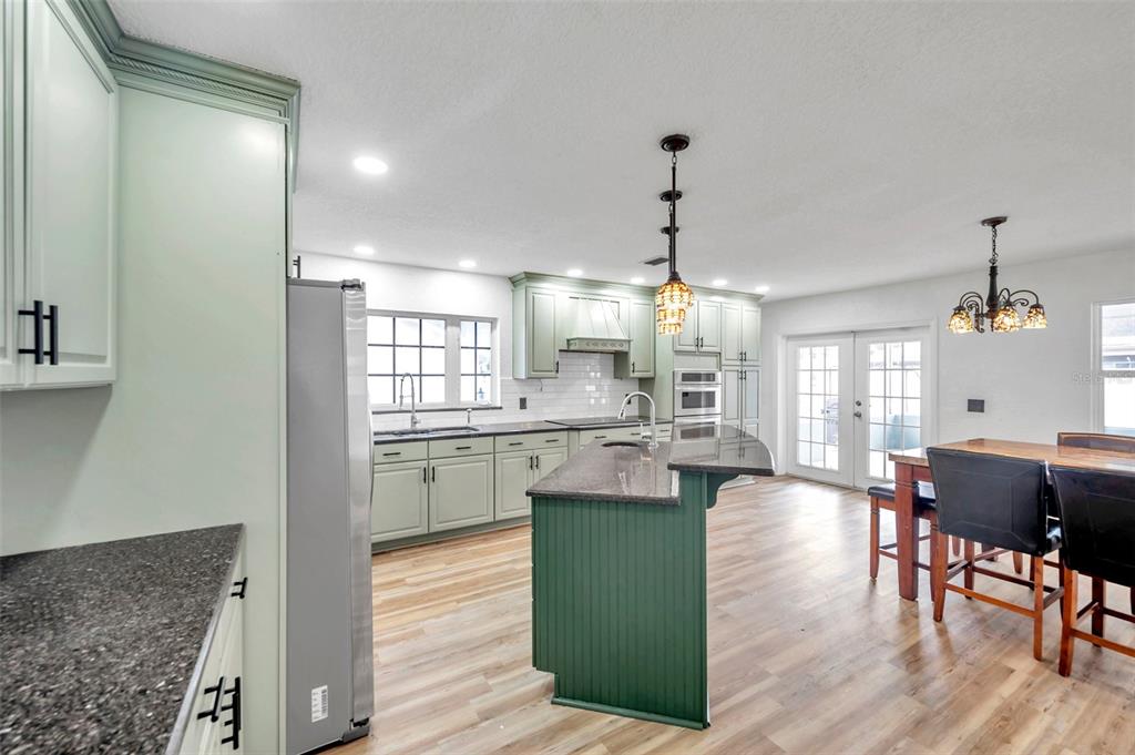 1520 Windmill Pointe Road Palm Harbor, FL 34685 - Photo 20 of 64 a view of a dining room with furniture window and wooden floor