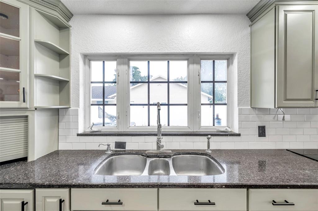 1520 Windmill Pointe Road Palm Harbor, FL 34685 - Photo 23 of 64 a kitchen with granite countertop a sink and a counter top space