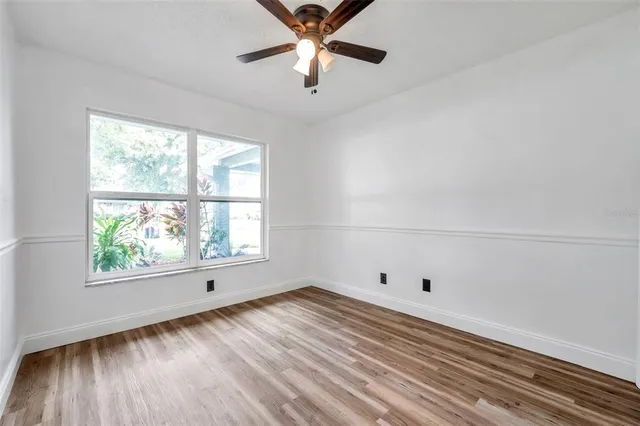 wooden floor in an empty room with a window