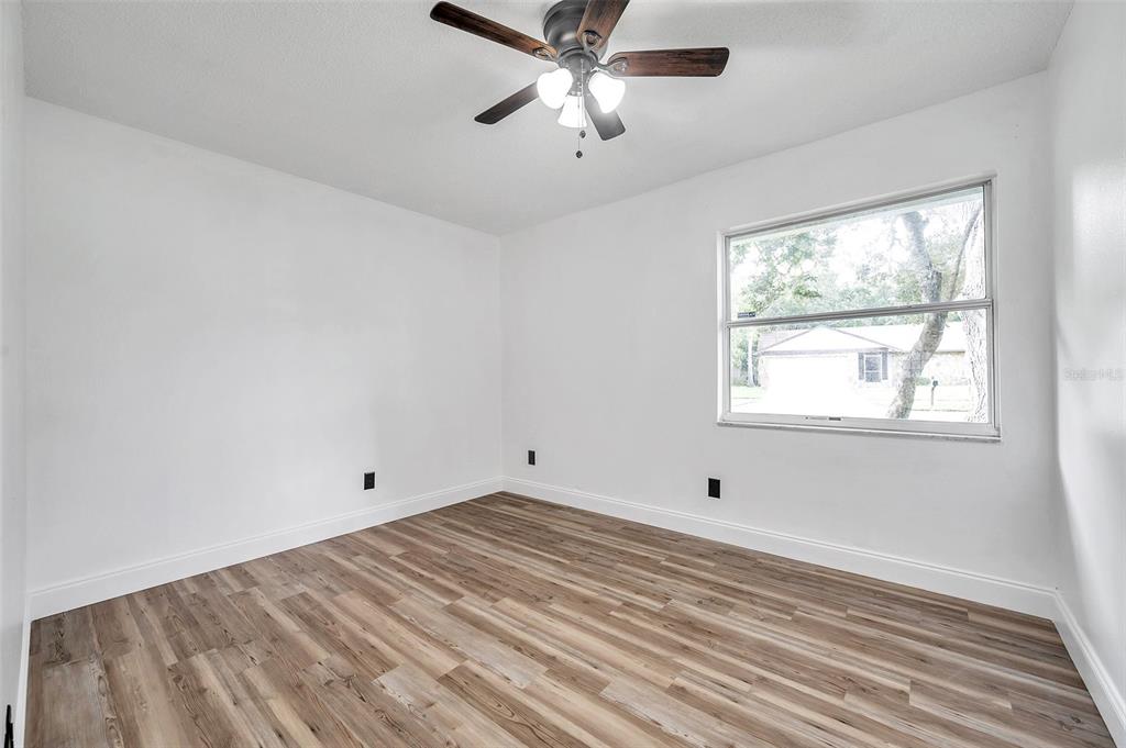 1520 Windmill Pointe Road Palm Harbor, FL 34685 - Photo 31 of 64 a view of empty room with wooden floor and fan