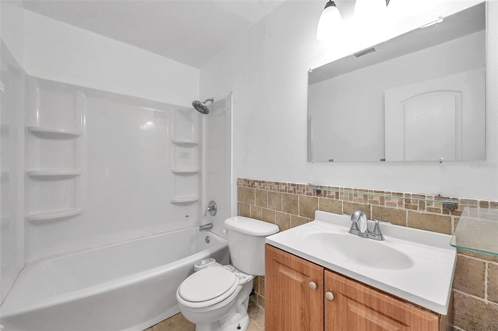 1520 Windmill Pointe Road Palm Harbor, FL 34685 - Photo 34 of 64 a bathroom with a sink toilet and shower