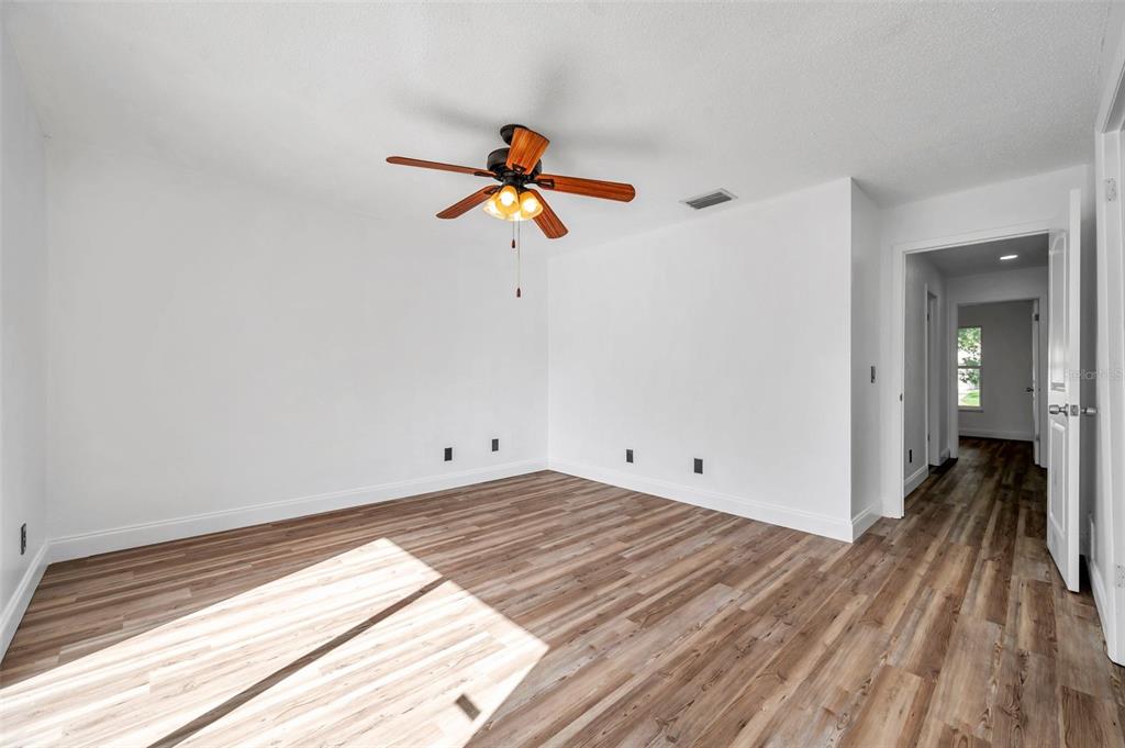 1520 Windmill Pointe Road Palm Harbor, FL 34685 - Photo 37 of 64 a view of a room with wooden floor and ceiling fan