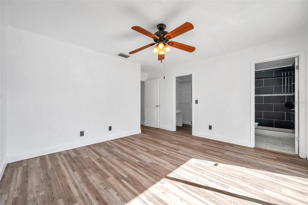 1520 Windmill Pointe Road Palm Harbor, FL 34685 - Photo 38 of 64 a view of empty room with wooden floor and ceiling fan