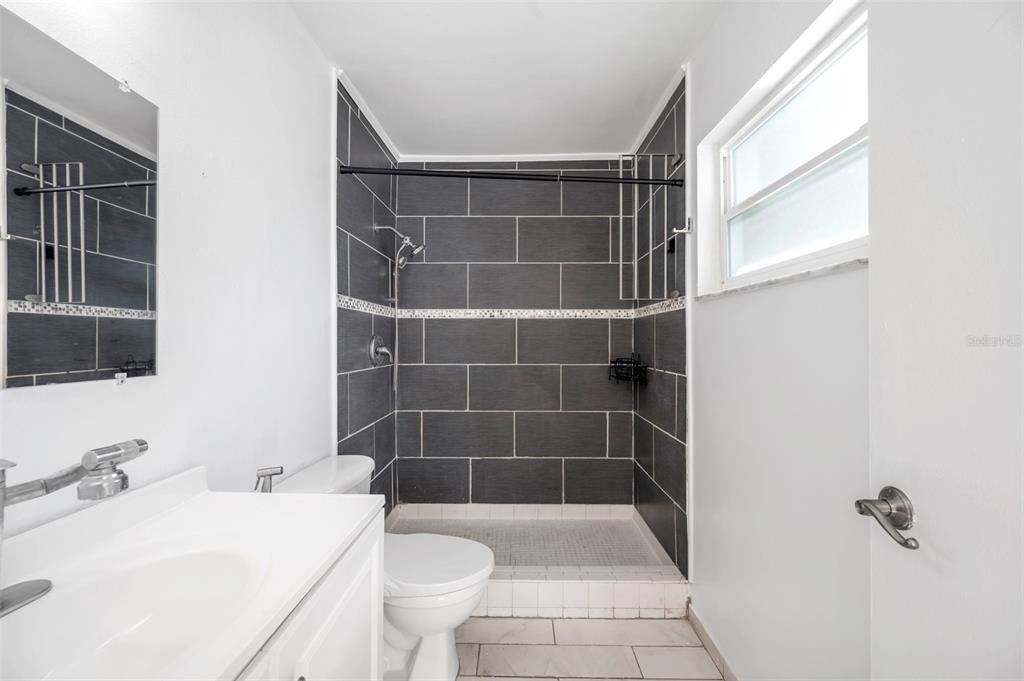 1520 Windmill Pointe Road Palm Harbor, FL 34685 - Photo 39 of 64 a bathroom with a sink a toilet and shower