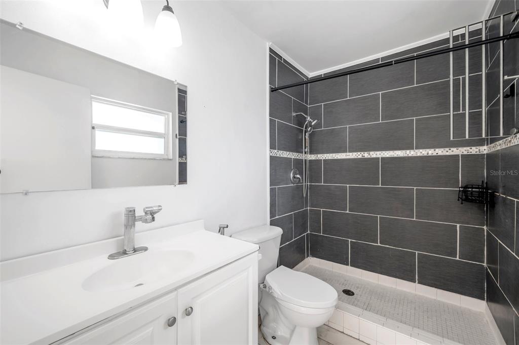 1520 Windmill Pointe Road Palm Harbor, FL 34685 - Photo 40 of 64 a bathroom with a sink toilet and shower