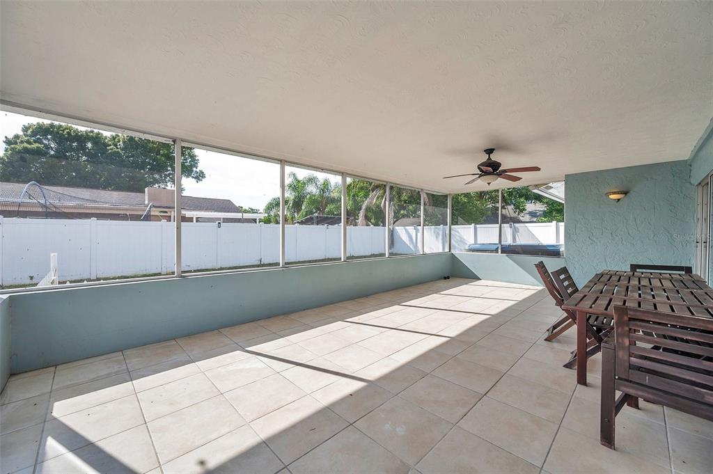 1520 Windmill Pointe Road Palm Harbor, FL 34685 - Photo 43 of 64 a view of a patio with table and chairs with wooden floor