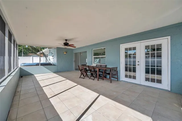 an aerial view of residential houses with outdoor space and trees
