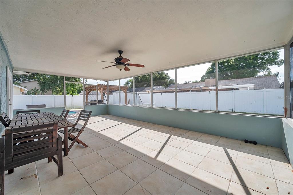1520 Windmill Pointe Road Palm Harbor, FL 34685 - Photo 46 of 64 a view of a patio with table and chairs with wooden floor