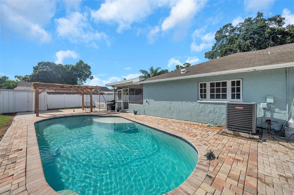1520 Windmill Pointe Road Palm Harbor, FL 34685 - Photo 48 of 64 a swimming pool with outdoor seating yard and barbeque oven