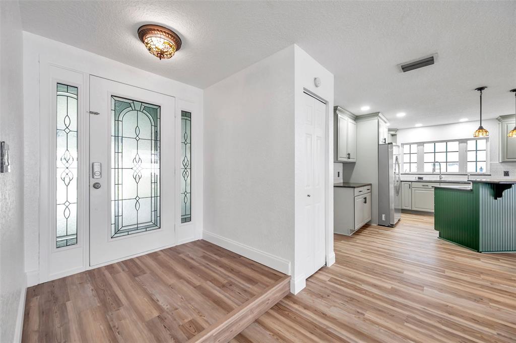 1520 Windmill Pointe Road Palm Harbor, FL 34685 - Photo 8 of 64 a view of a room with wooden floor and windows