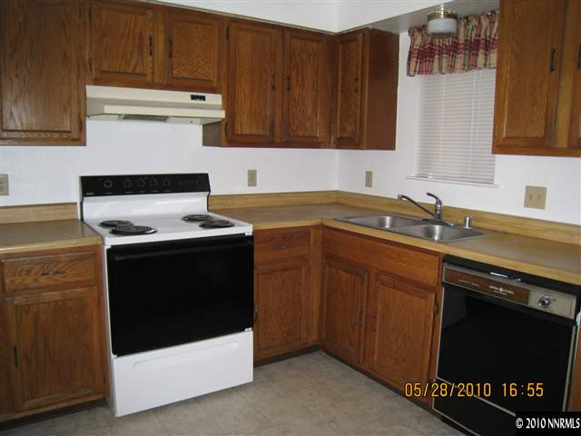 3908 Kings Row Reno, NV 89503 - Photo 3 of 8 a kitchen with granite countertop a stove sink and cabinets