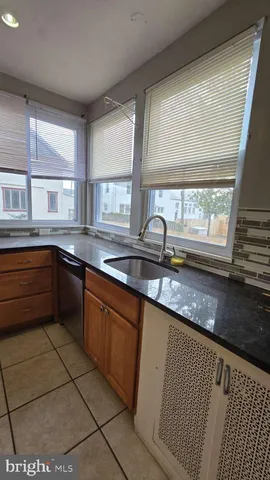 a kitchen with stainless steel appliances granite countertop a sink and a counter space